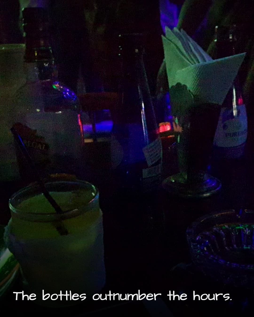 Three Horse Bar dim table with bottles